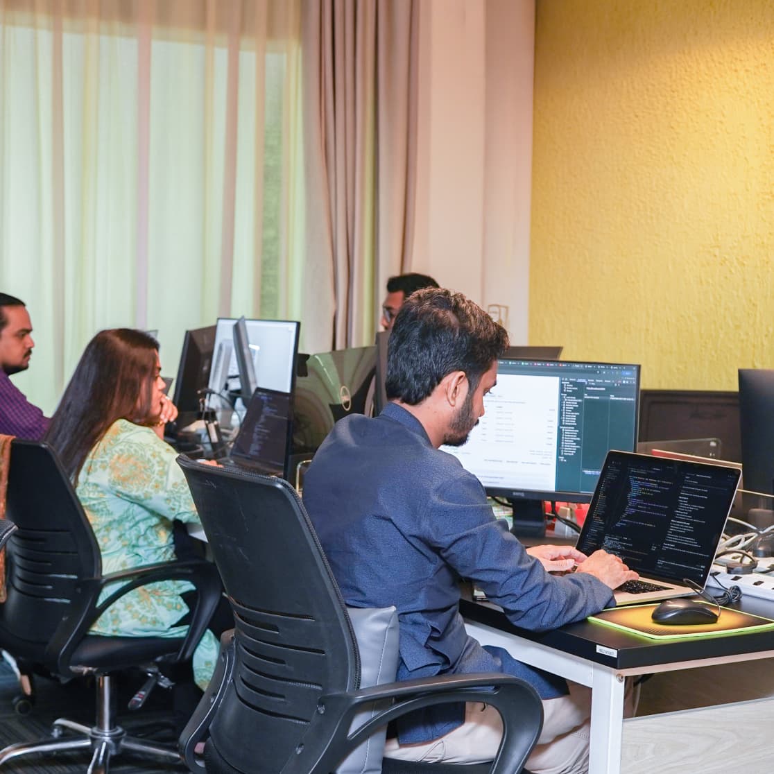 Team of product and engineering professionals collaborating at desks in a modern office, representing loyalty platform development.