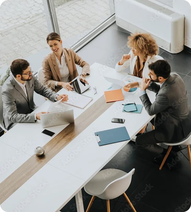 A team meeting viewed from above a conference table