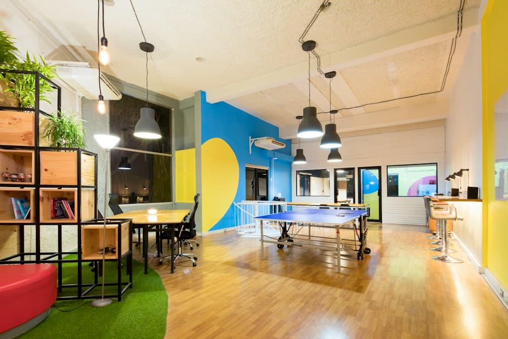Open-plan games area with a table-tennis table and pendant lights