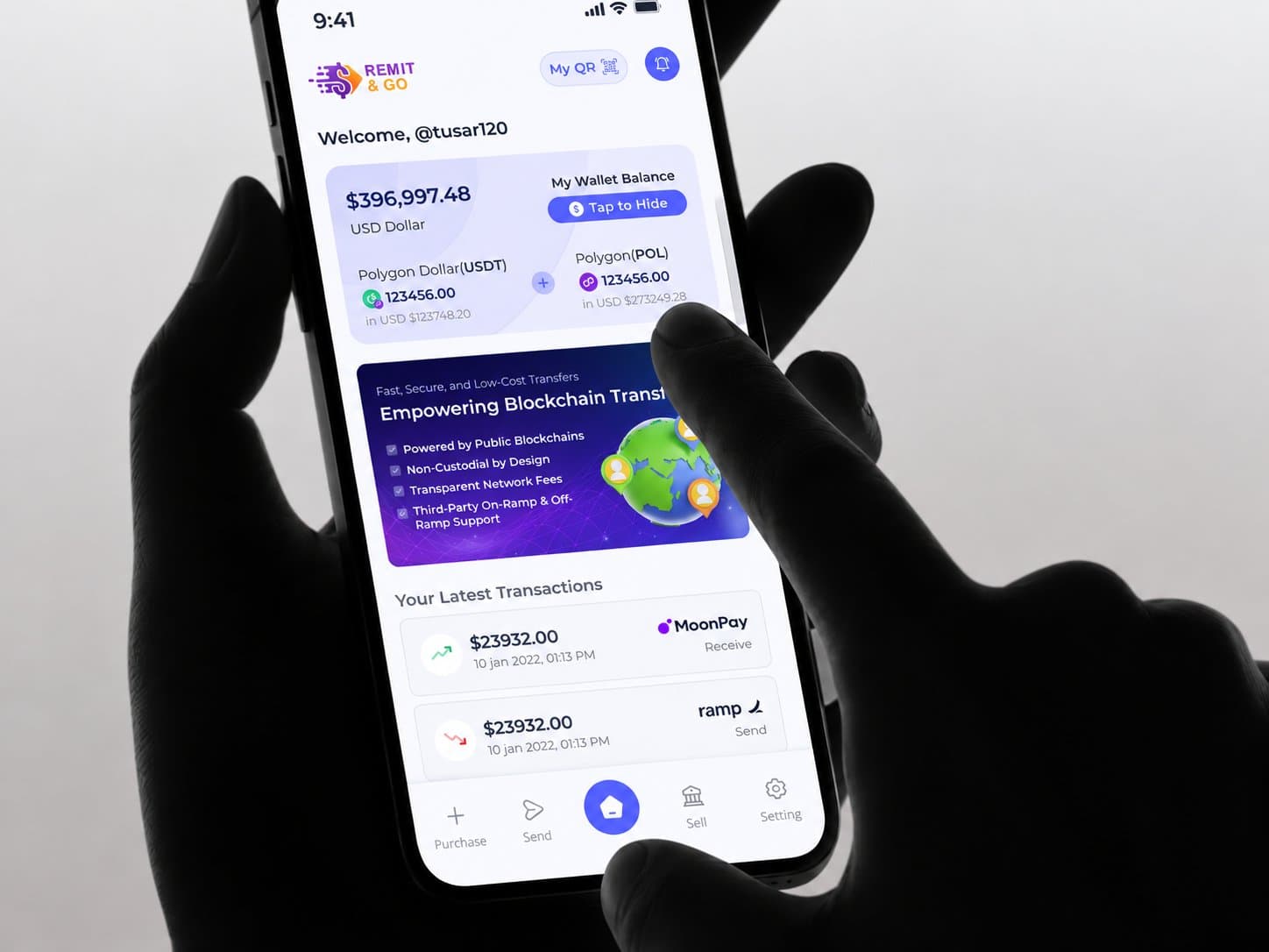 Silhouetted hand holding a phone and tapping the Remit&Go wallet home screen showing balance, blockchain transfer banner and recent transactions