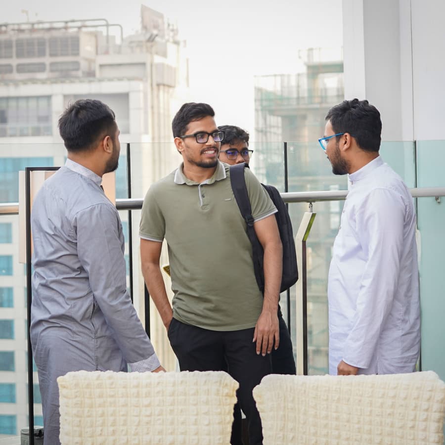 Nagorik engineers talking together on an office balcony