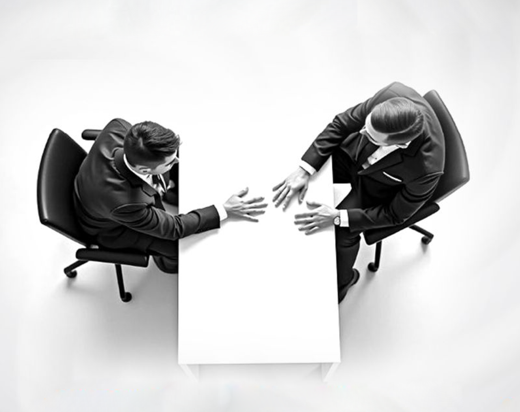 Two business executives meeting across a desk to align on AI strategy